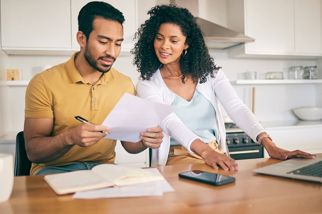 A couple reviewing bills together at home.
